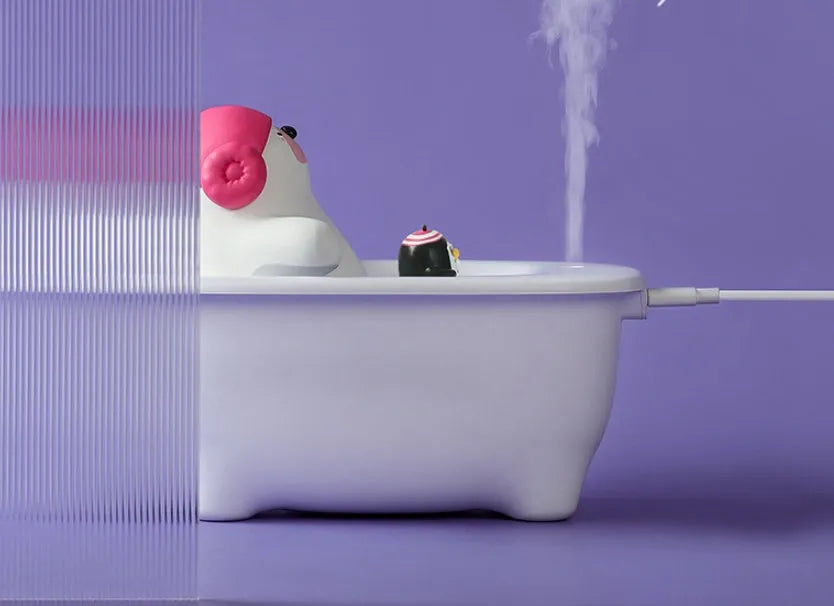White USB-powered air humidifier and aromatherapy diffuser unit on a desk.