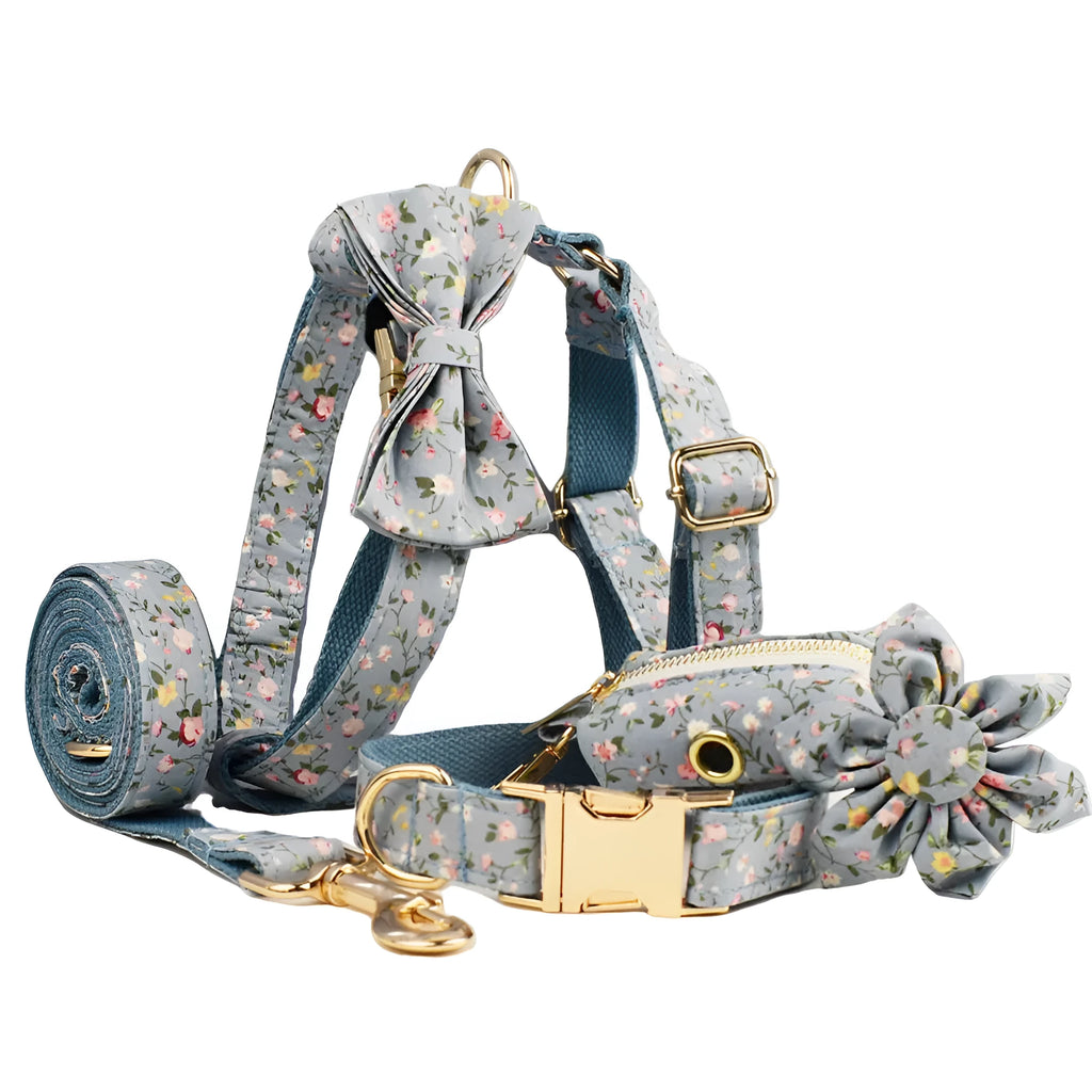 Blue floral dog collar and matching leash, bow, vest, and waste bag holder five-piece pet set.