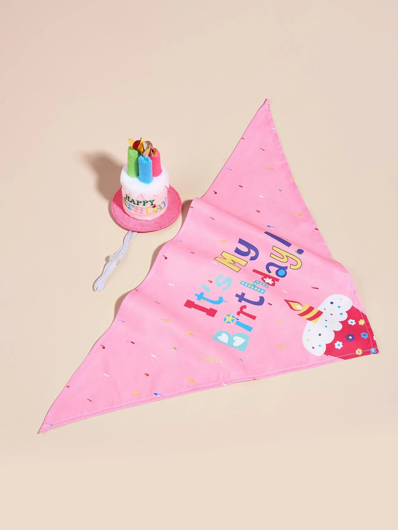 Printed polyester dog birthday hat and drool towel set in cartoon style with blue and pink colour options.