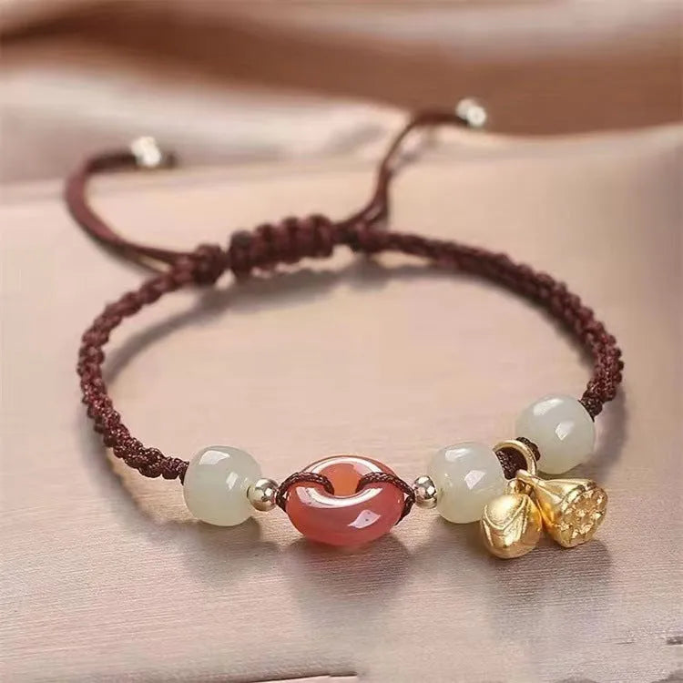 Hetian jade bracelet with constellation design and a brown carrying strap fastened with a Peace Buckle.