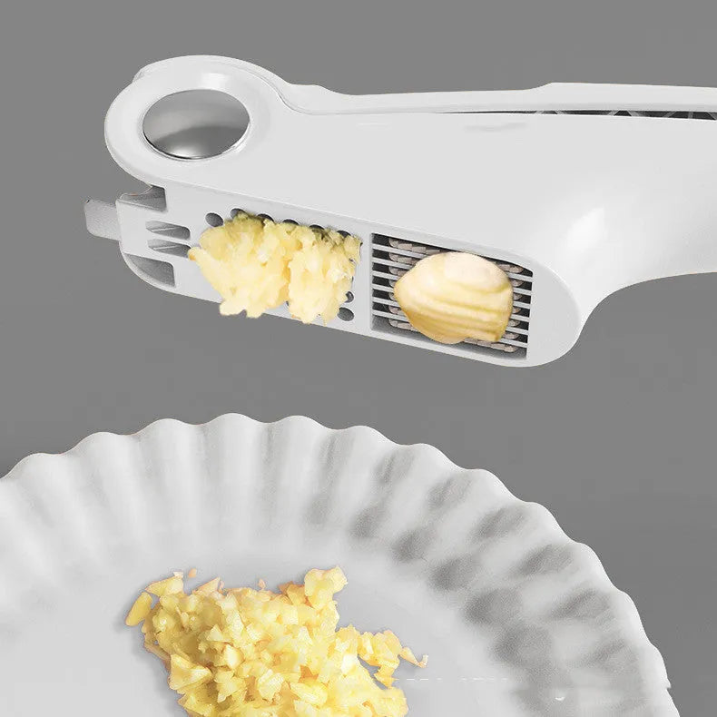 White manual garlic press made of ABS plastic and stainless steel on a kitchen counter.