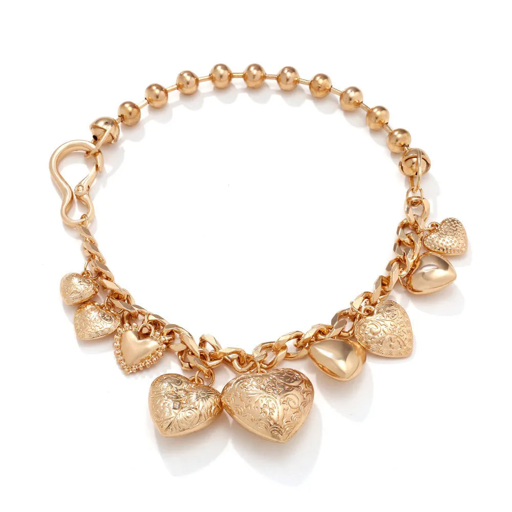 Carved heart-shaped pendant necklace on a metal chain, shown in gold and white K colour options.
