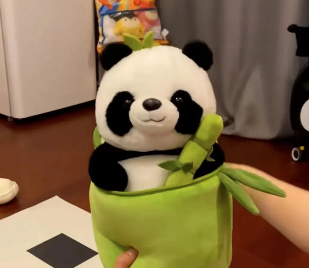 Black and white panda plush doll holding a simulated bamboo tube, a soft decorative cushion.
