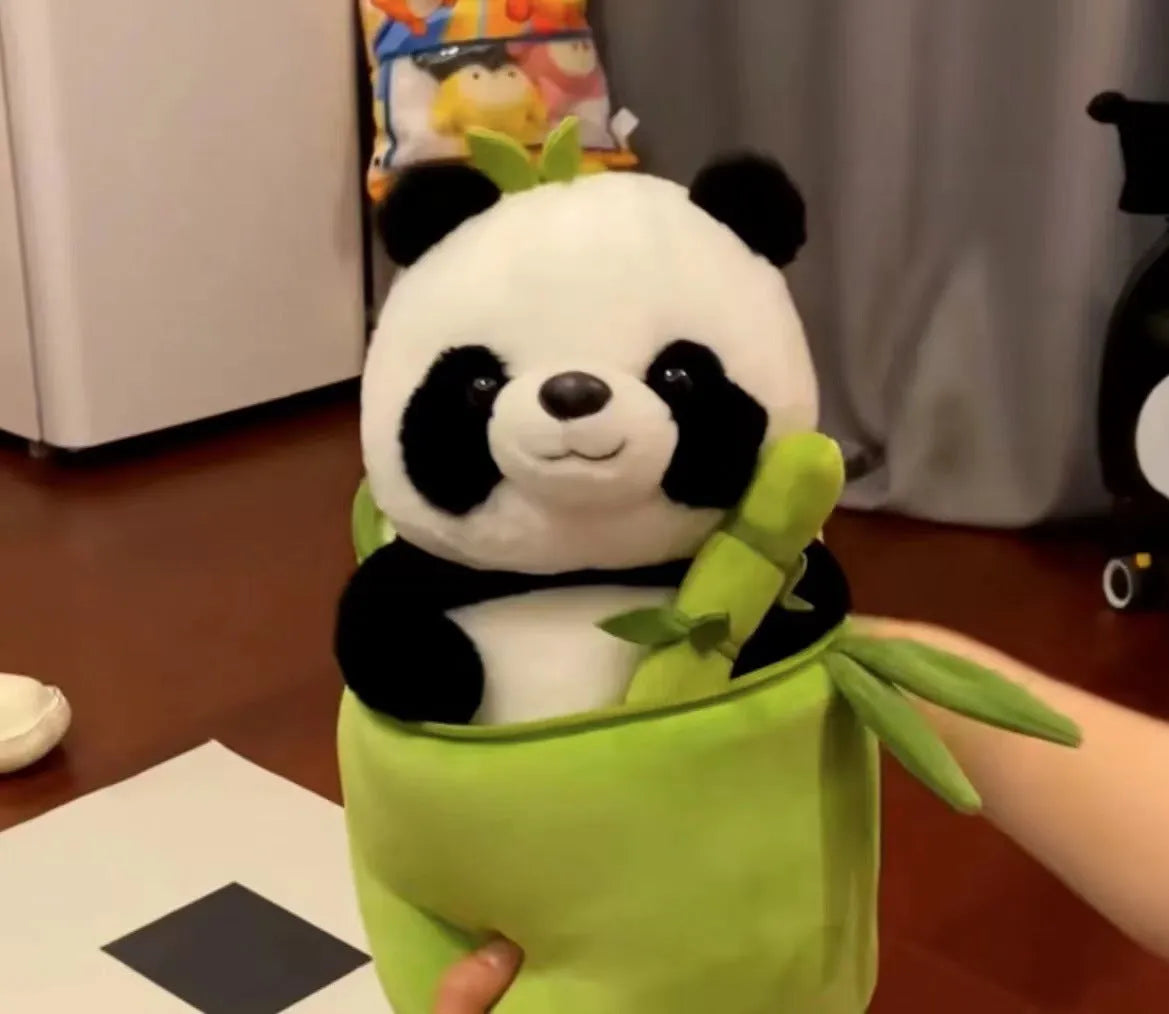 Black and white panda plush doll holding a simulated bamboo tube, a soft decorative cushion.