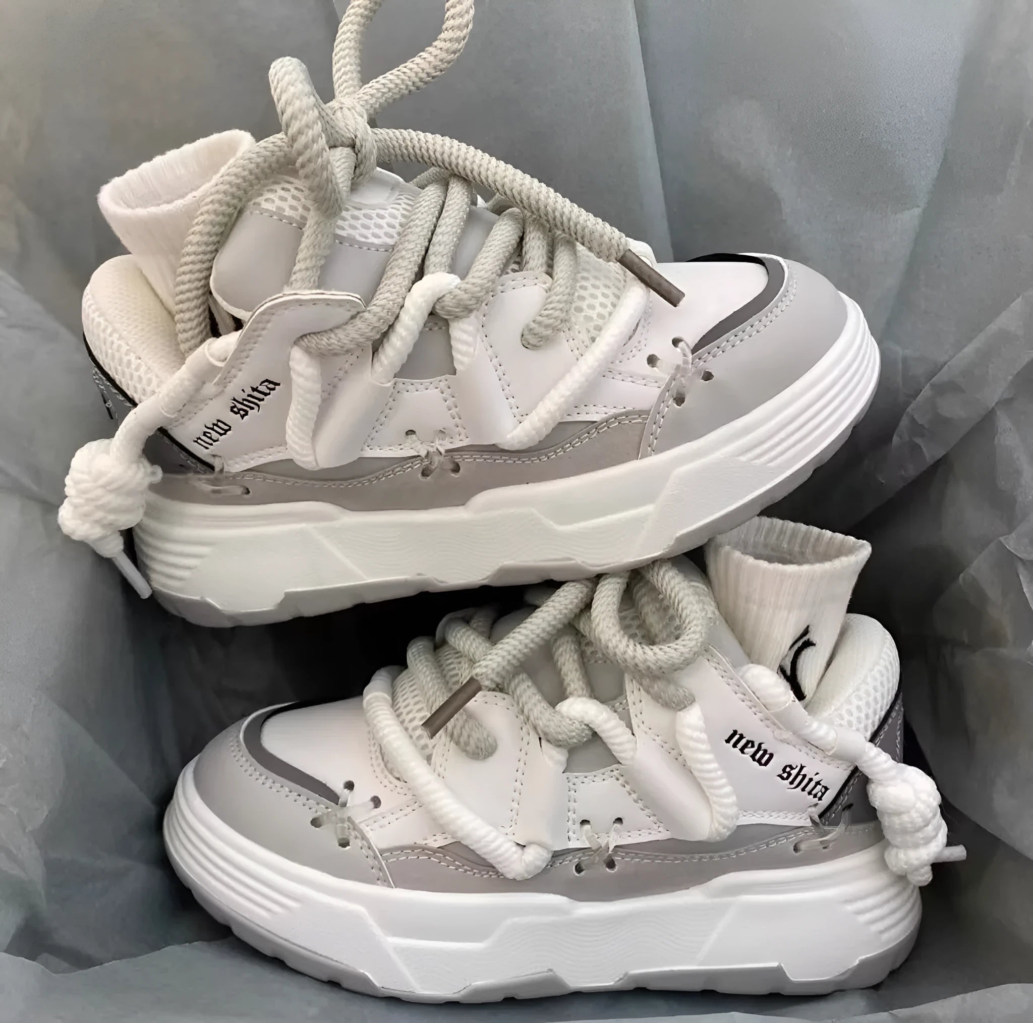 Women's grey chunky platform sneakers with thick rubber sole and lace-up front