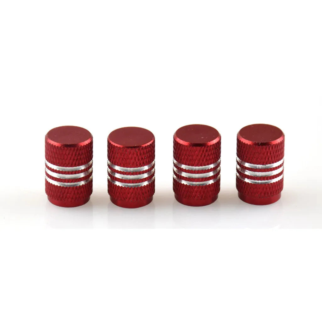 Set of aluminium alloy tyre valve caps in various metallic colours including red, blue, black, gold and silver.