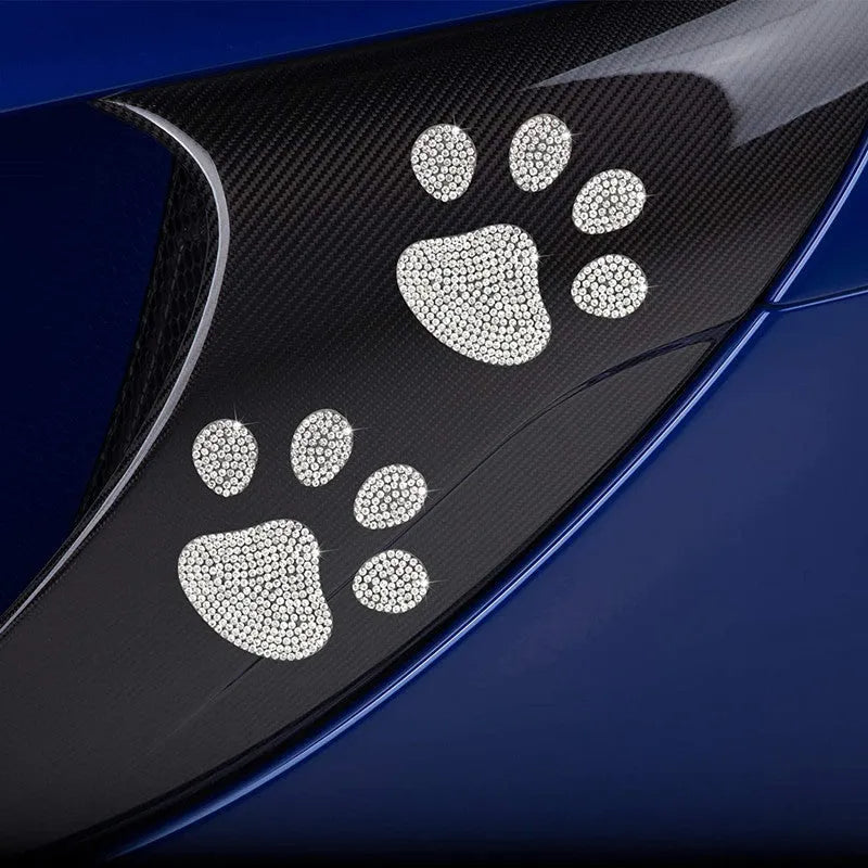 Close-up of a diamond-encrusted glass car sticker showing butterfly and bear claw design options.