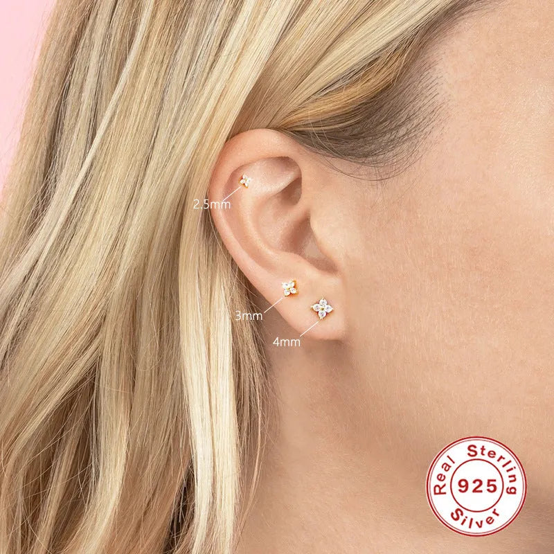 S925 sterling silver stud earrings with a geometric petal and crystal flower design in gold or platinum finish.