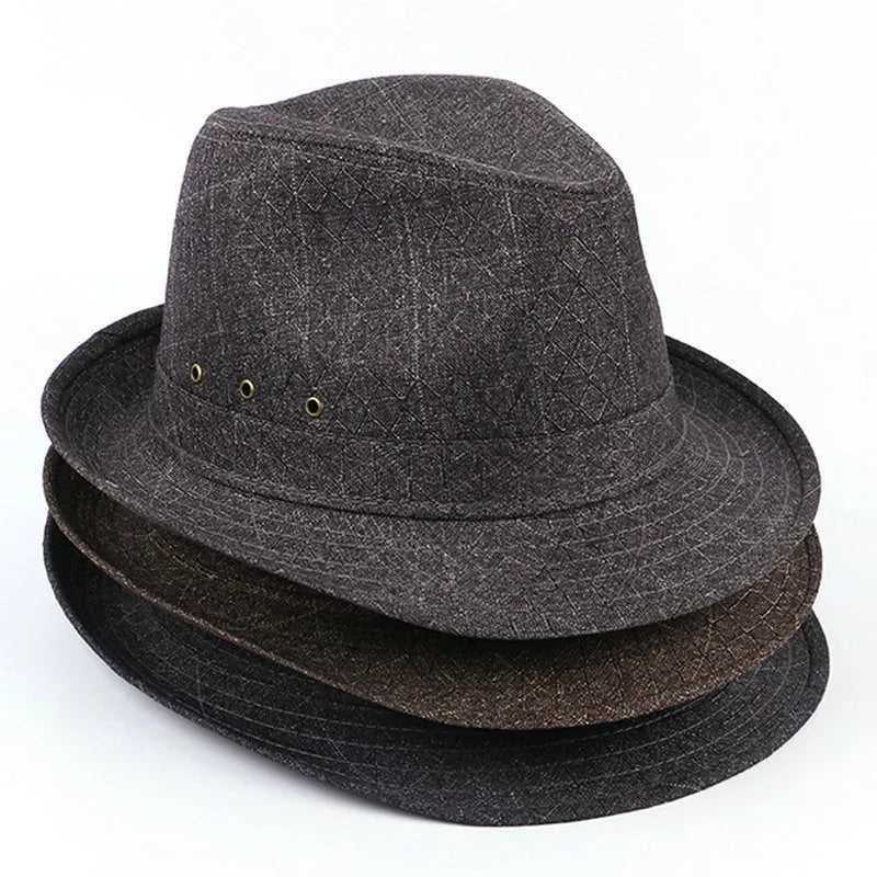 A classic brown fedora hat with a pinched crown and medium brim on a wooden table, showing its structured silhouette.