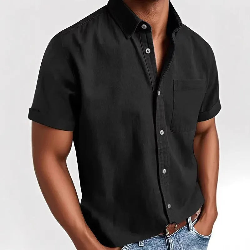 Man wearing a loose-fit grey short sleeve casual shirt with a single-breasted, cardigan-style design.