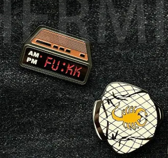 Black metal retro electronic alarm clock brooch pin with original design on a jacket lapel