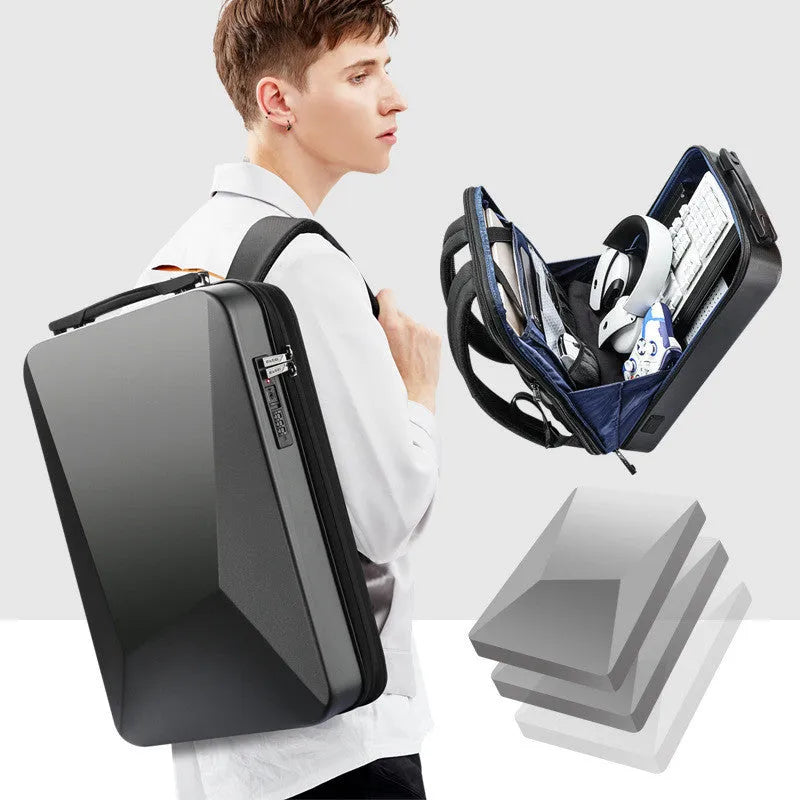 Men's hard-shell titanium silver backpack with lock, open to show laptop compartment and internal organisation pockets.