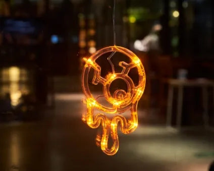 Halloween LED window lights with suction cups showing ghost, spider, and pumpkin decorations