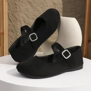 Black canvas low-top flat fisherman shoes with a rubber sole on a plain background.