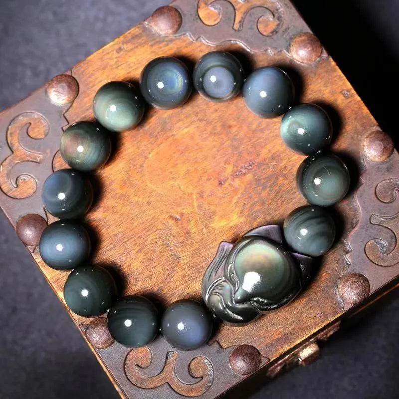 Black obsidian fox carved bracelet showing detailed animal design on polished gemstone