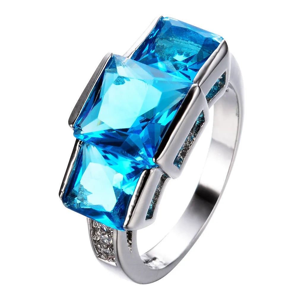 Colourful women's metal ring in copper with electroplated finish, showing geometric and rainbow design.