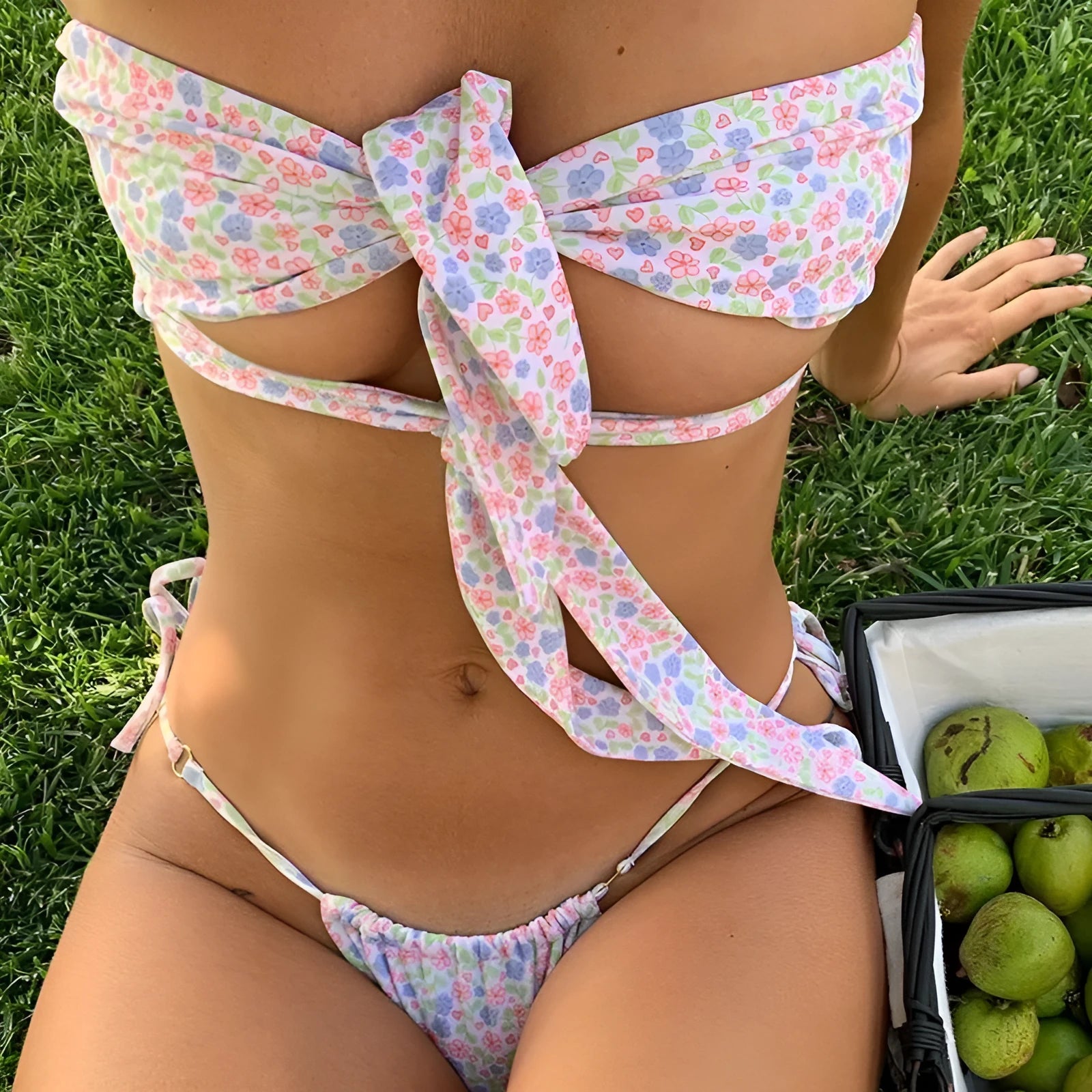 Women's one-piece swimsuit with lace-up front and built-in support pad, shown in a floral print.