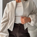 Women's off-shoulder short coat with lantern sleeves in polyester fabric, shown in milky white colour
