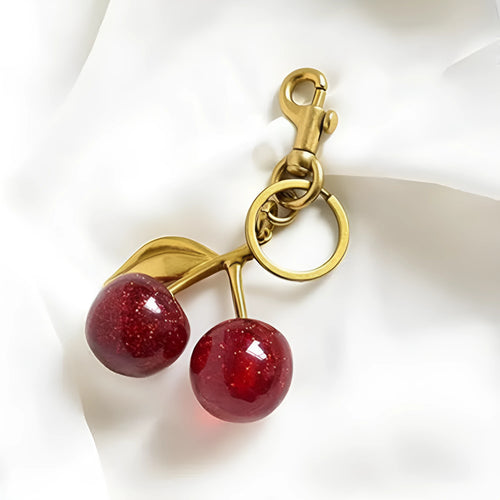 Three-dimensional red zinc alloy cherry pendant charm on a key ring.