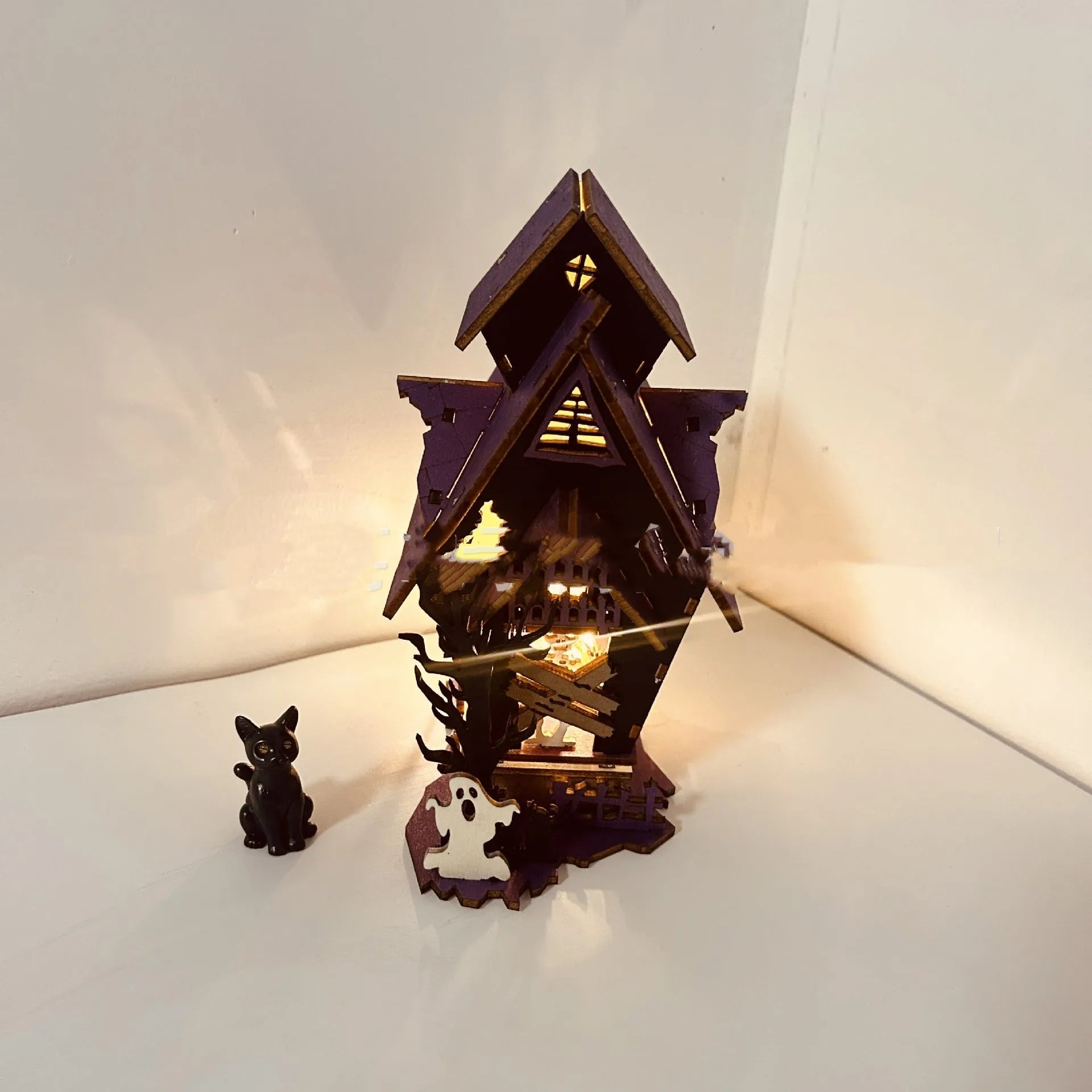 Wooden DIY glowing haunted house Halloween table decoration with luminous details
