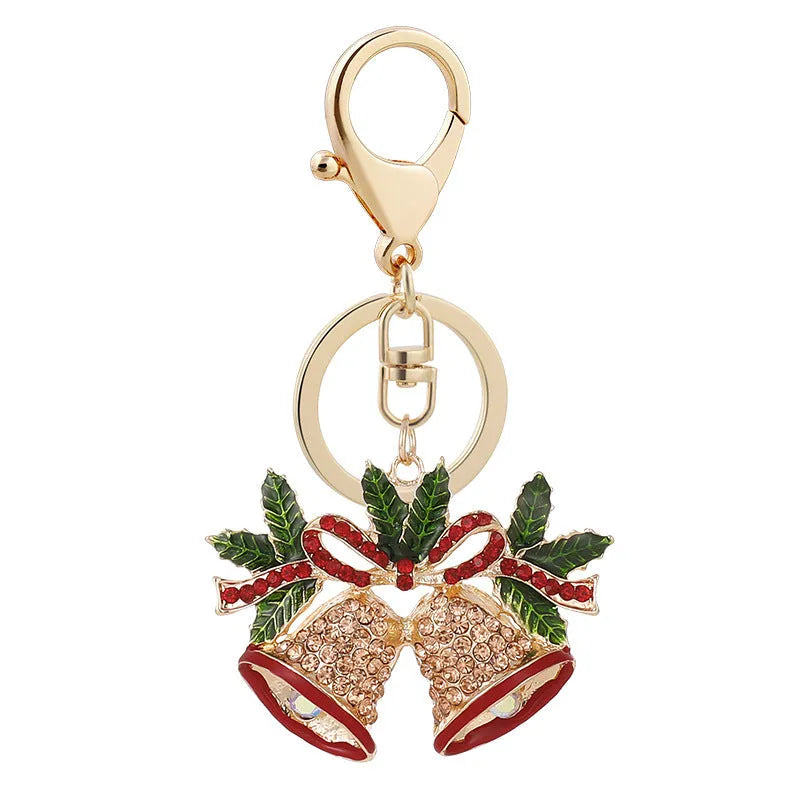 Diamond studded metal Christmas bell keychain in European style on a white background