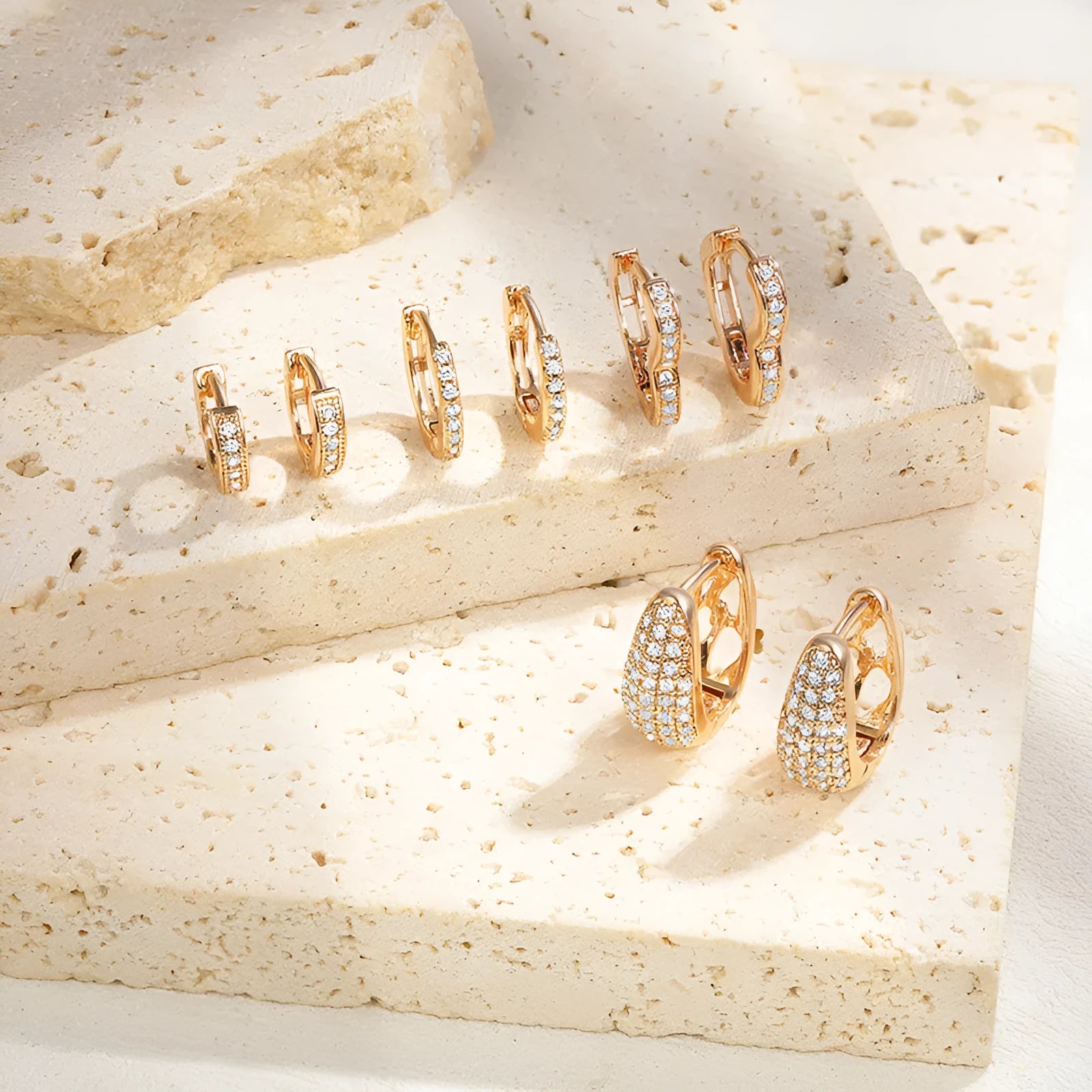 Gold plated heart-shaped ear clip earrings with zircon gang drill details on a white background.
