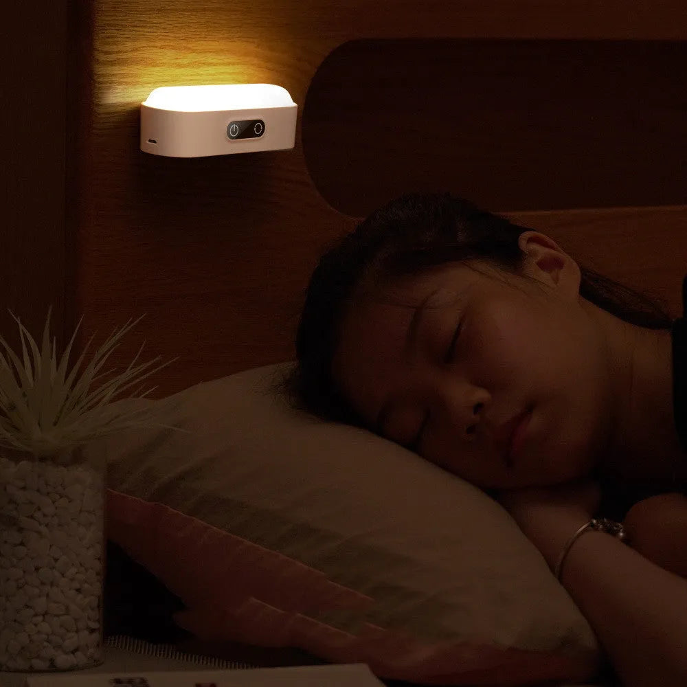 White magnetic USB rechargeable LED night light with touch controls mounted on a metal surface.