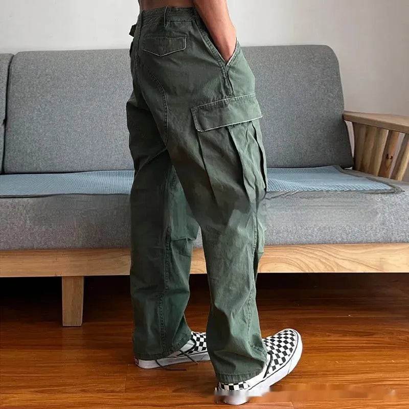 Men's loose fit washed cotton paratrooper pants in Army Green with large pockets, flat lay