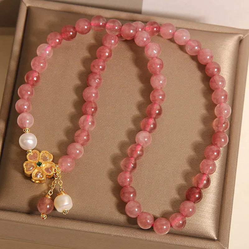 Women's twin four-leaf clover charm bracelet with strawberry quartz crystals and alloy inlay settings.
