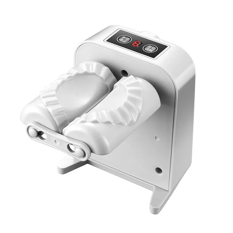 White automatic electric dumpling maker machine with USB charging cable on a kitchen counter