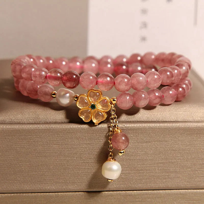 Women's twin four-leaf clover charm bracelet with strawberry quartz crystals and alloy inlay settings.