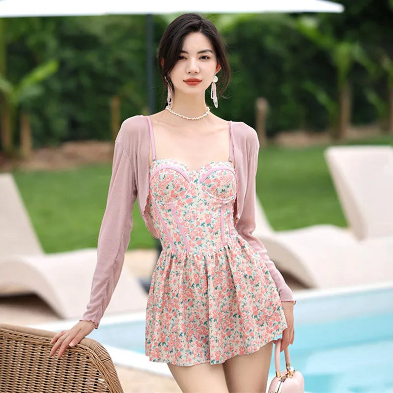 Pink floral one-piece women's swimsuit with suspenders, shown with matching smock.